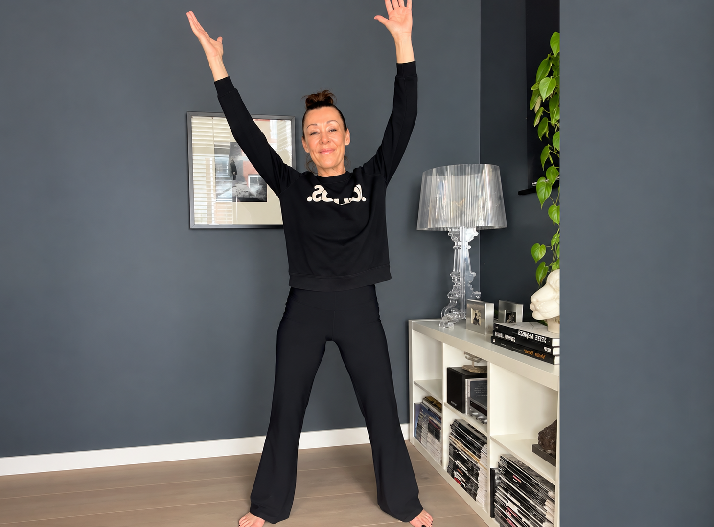 Dominique Boesten smiling while practising a gentle Qigong movement